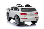 White kids' ride-on SUV toy modeled after an Audi Q5, viewed from the rear-left side with a steering wheel visible in the cabin (informative)