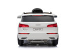 Rear view of a white Audi Q5 SUV with taillights illuminated and license plate reading 'Audi Q5'