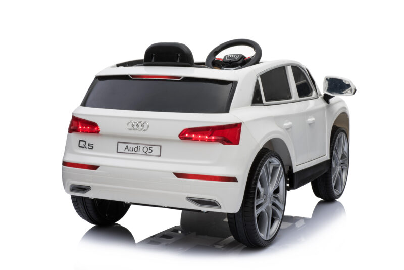 White toy Audi Q5 with steering wheel, shown from rear-right on a white background.