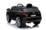 Black Audi Q5 toy ride-on car, rear-right view with silver wheels and red taillights, reflective surface below.