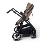 Stroller with brown seat fabric and black frame, viewed from the side, showing large wheels and storage basket beneath.
