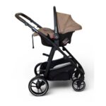 Black baby stroller with tan canopy and built-in storage basket underneath