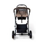 Front view of a beige infant car seat mounted on a black stroller frame with a brown handlebar and large wheels on each side