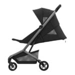 Black stroller with a silver frame and large canopy, side view showing three wheels and reclining seat.