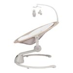 Infant baby swing with a beige fabric seat, curved white frame, and a hanging mobile with owl and cloud toys.