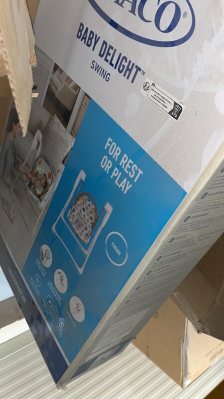 Box for Baby Delight Swing packaging showing a baby swing image and the words "For rest or play" on a blue panel.