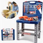 Toy tool bench with orange and gray plastic tools laid out on a blue work surface; a child drills a wooden project nearby.