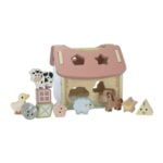 Wooden toy barn playset with animal-shaped blocks and animals like cow, duck, sheep, horse arranged around a pastel pink roofed barn.