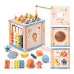 Colorful wooden activity cube for kids featuring a clock face, bead abacus on the side, and shape panels for sorting in pastel peach, blue, and orange tones.