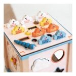Colorful wooden toy cash register with duck-shaped spinners and cloud/balloon decorations on top.