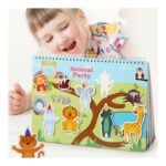 Young girl looking excited at a colorful animal party pop-up book for kids with cartoon animals pieces on the pages.