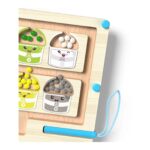 Montessori-style wooden learning board with labeled cups holding colored beads (green, white, yellow, grey) and a blue attached marker pen area.
