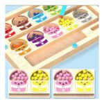 Colorful wooden color-matching puzzle with numbered cups and small balls in each cup, and two bottom panels showing pink and yellow containers with balls.