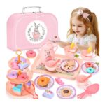 Girl playing with a pastel pink children's tea party set, including a pink box, teapot, cups, and toy pastries laid out for a pretend tea party.