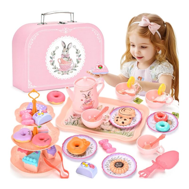Girl playing with a pastel pink children's tea party set, including a pink box, teapot, cups, and toy pastries laid out for a pretend tea party.
