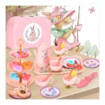 Pink toy tea party set on a table with pastries, teapot, and teacups for a pretend party, in a pastel playroom scene