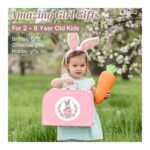 Young girl wearing bunny ears carries a pink gift bag and a large carrot outdoors; ad for kids' gifts (2–8 years).