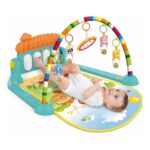 Baby lying on a colorful activity gym with a striped rainbow arch and hanging toys.
