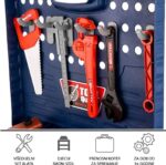 Blue pegboard with a kid's tool set: saw, ruler, and assorted red/black plastic tools hanging on hooks.