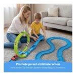 Mother and young boy playing with a bright blue and green toy race track on a living room rug, promoting parent-child interaction.