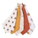 Five quilted baby blankets draped together in white with sun patterns, mustard, tan, rust, and cream with playful prints.