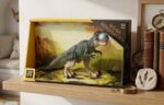 Green dinosaur toy in a yellow-framed display box on a wooden shelf with books nearby, resembling a mini exhibit on a living room shelf.
