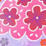 Decorative floral pattern with oversized pink flowers outlined in white on a purple background