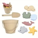 Set of beige plastic sand toys including a bucket with handle and a small shovel, plus several shell and sea animal molds (crab, shell, scallop, whale, starfish).