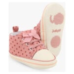 Pink polka-dot toddler high-top sneaker with a bow on the laces and a cream sole.