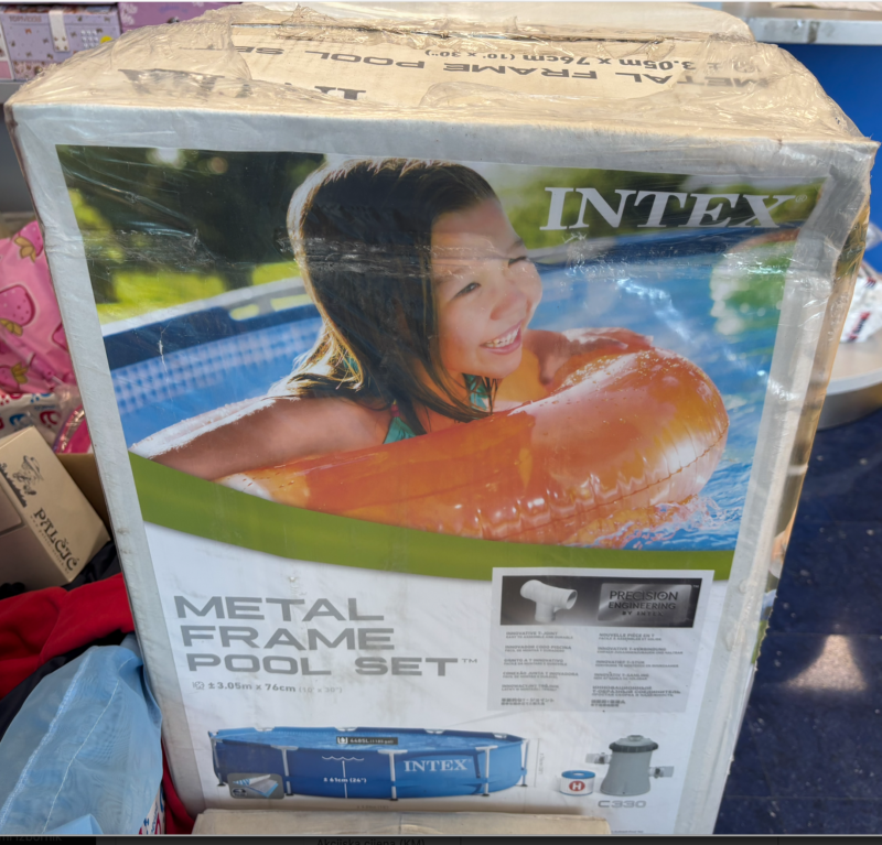Box for an Intex Metal Frame Pool Set featuring a smiling child in a pool float tube by the water edge